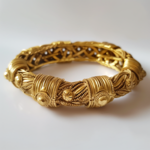 A bold bracelet, gold bangle with ancient motifs